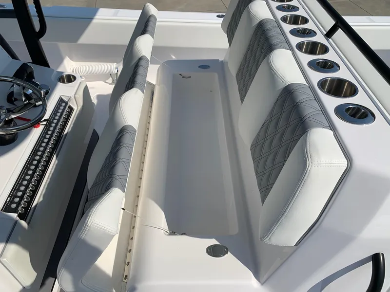 Slide: The Image of 2024 Invincible 35 Catamaran interior seating and console with cup holders. - 14