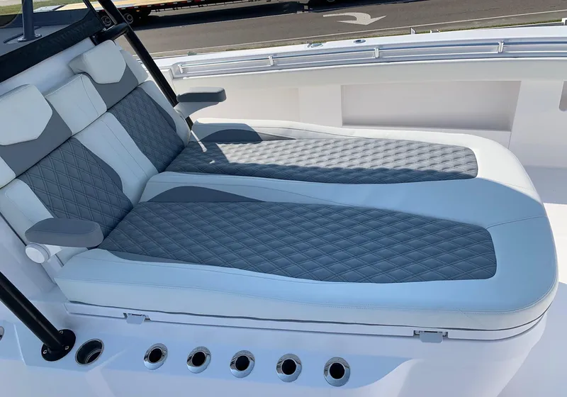 Slide: The Image of 2024 Invincible 35 Catamaran with luxurious gray and white cushioned seating. - 21