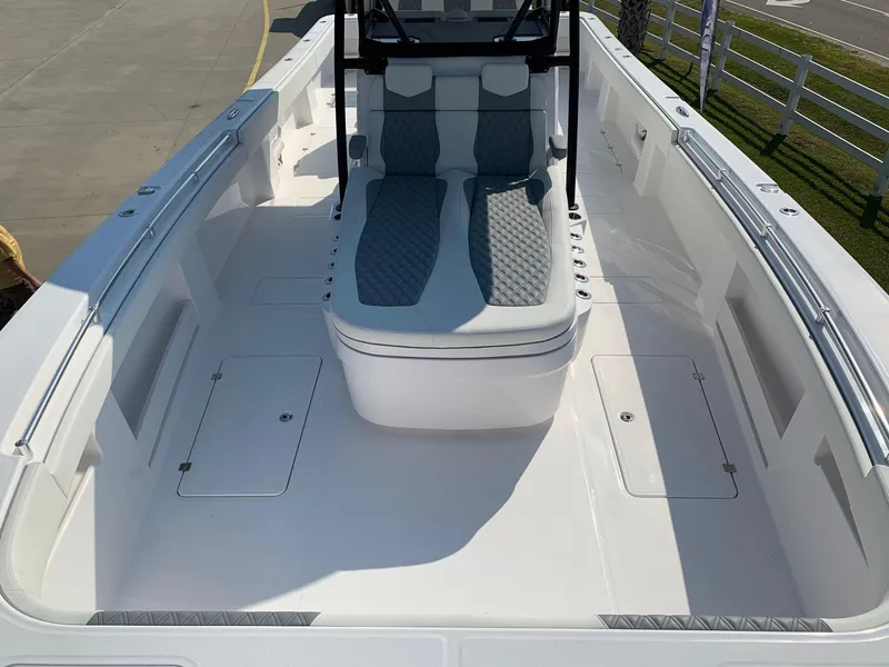 Slide: The Image of 2024 Invincible 35 Catamaran boat interior with cushioned seating and storage compartments. - 23