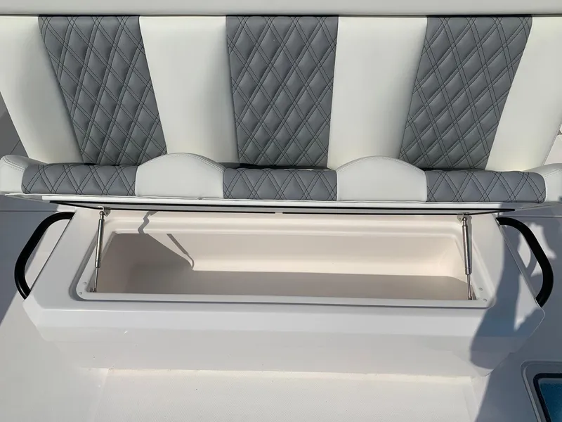 Slide: The Image of 2024 Invincible 35 Catamaran seat with storage compartment open. - 4