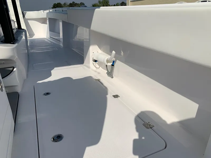 Slide: The Image of 2024 Invincible 35 Catamaran deck with storage compartments and clean white finish. - 9