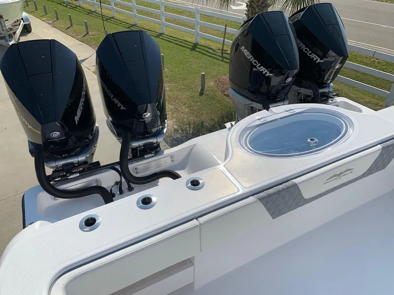 Slide: The Image of 2024 Invincible 35 Catamaran with quad Mercury outboard engines and a livewell. - 11