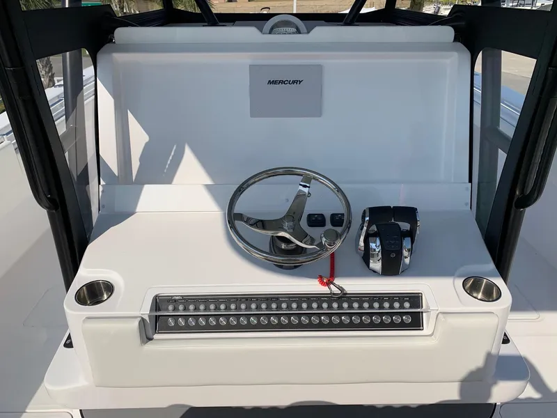 Slide: The Image of 2024 Invincible 35 Catamaran helm with Mercury controls and steering wheel. - 13
