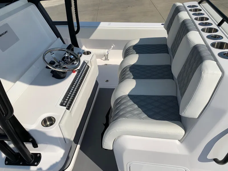 Slide: The Image of 2024 Invincible 35 Catamaran cockpit with steering wheel and cushioned seating. - 15