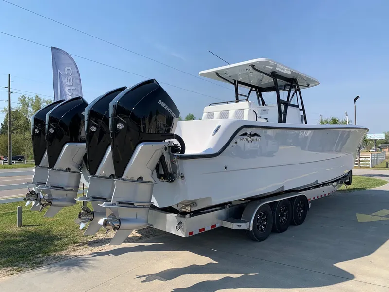Slide: The Image of 2024 Invincible 35 Catamaran with quad Mercury outboard engines on a trailer. - 2