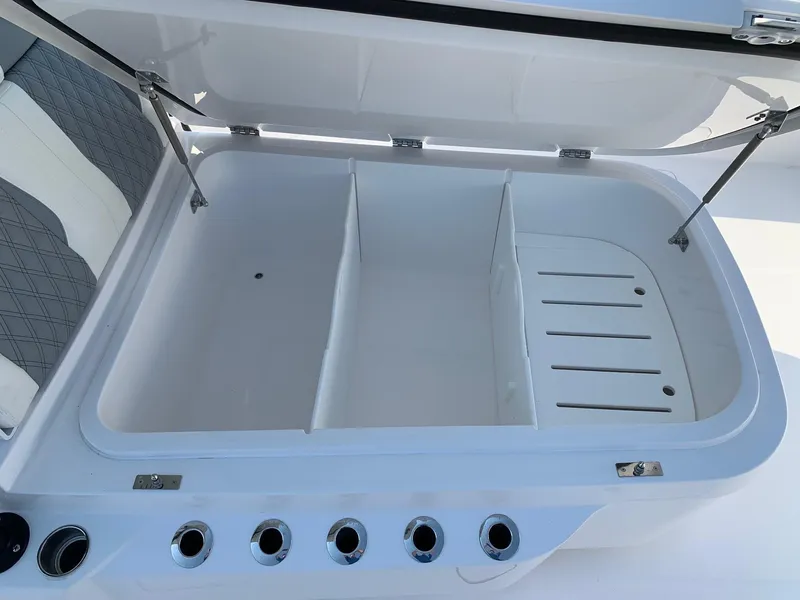 Slide: The Image of Open storage compartment on 2024 Invincible 35 Catamaran boat with dividers and rod holders. - 20