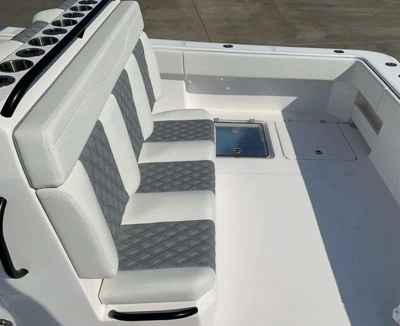 Slide: The Image of 2024 Invincible 35 Catamaran with white and gray diamond-stitched seating. - 5