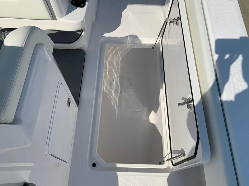 Slide: The Image of 2024 Invincible 35 Catamaran open storage compartment with white interior. - 8