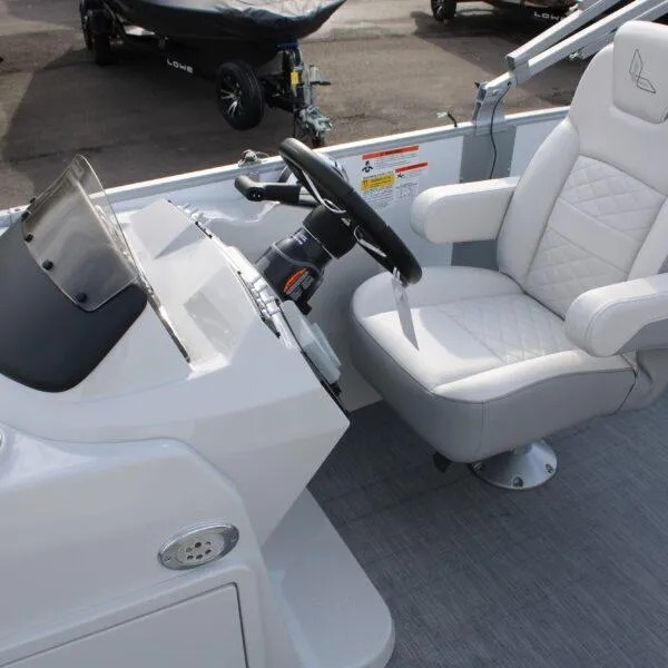 Slide: The Image of 2023 Lowe SS210 W Super Sport boat interior with steering wheel and captain's chair. - 6