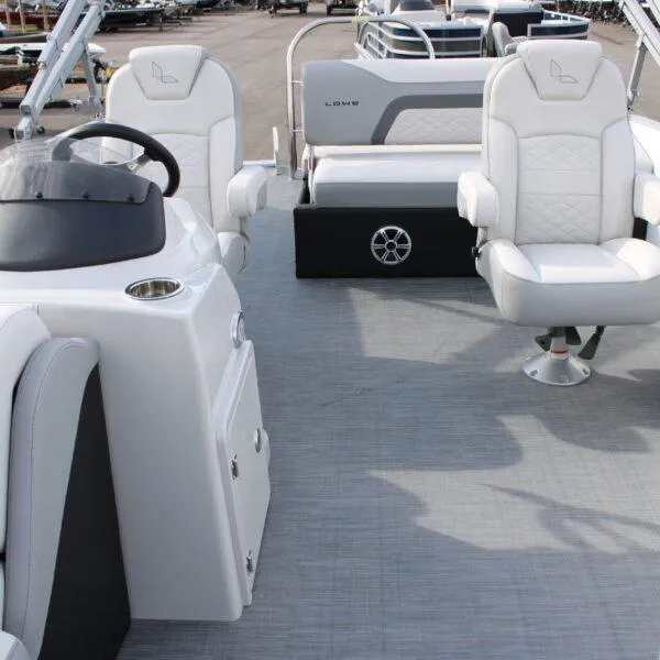Slide: The Image of 2023 Lowe SS210 W Super Sport boat interior with white seating and steering console. - 7