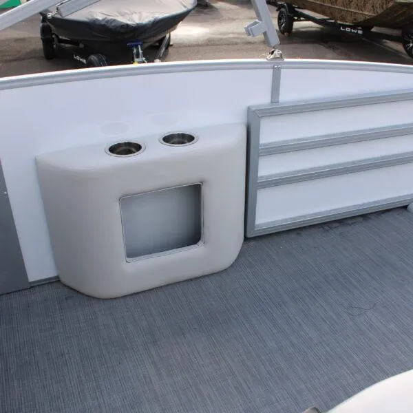 Slide: The Image of 2023 Lowe SS210 W Super Sport boat interior with cup holders and storage compartments. - 9