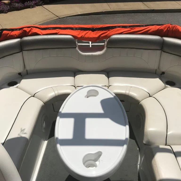 Slide: The Image of 2007 Yamaha Boats AR 230 interior with white seating and oval table. - 9