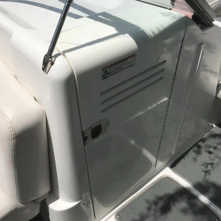 Slide: The Image of 2007 Yamaha Boats AR230 HO interior detail with white seating and door. - 4
