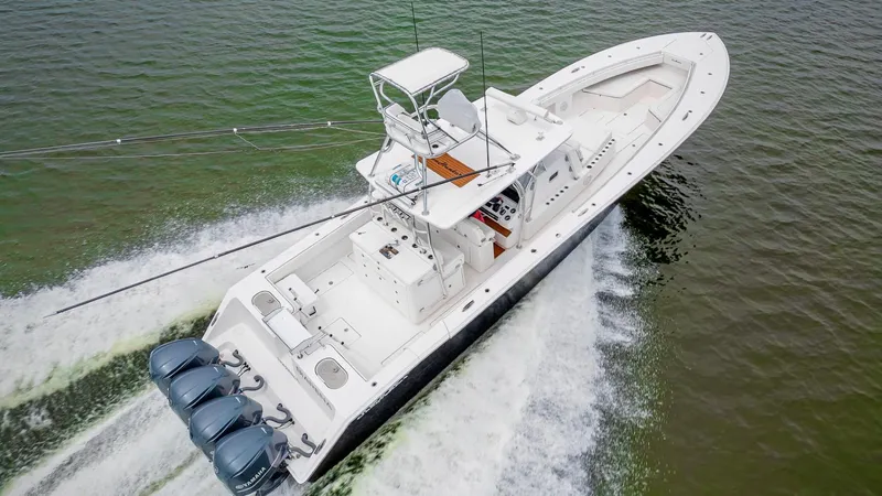 Slide: The Image of 2017 SeaHunter 45 boat cruising on water with four powerful outboard engines. - 10