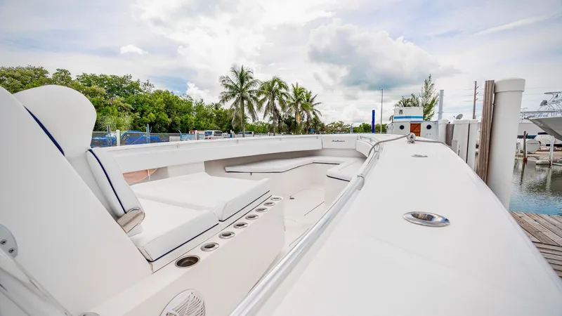 Slide: The Image of 2017 SeaHunter 45 boat with spacious deck and seating, docked near palm trees. - 19
