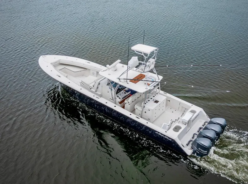 Slide: The Image of 2017 SeaHunter 45 boat cruising on calm water with multiple outboard engines. - 20
