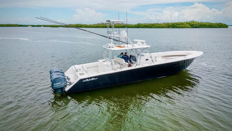 Slide: The Image of 2017 SeaHunter 45 boat on calm water with triple outboard engines. - 6