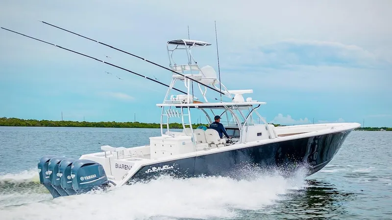 Slide: The Image of 2017 SeaHunter 45 boat cruising on water with multiple fishing rods. - 9