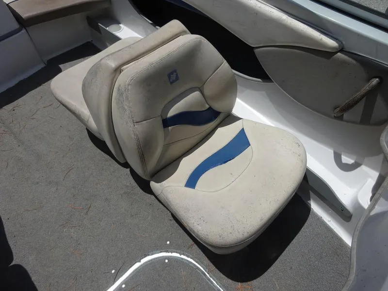 Slide: The Image of 2000 Four Winns 180 Horizon boat interior seating with blue and white upholstery. - 11