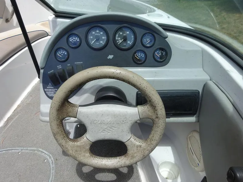 Slide: The Image of 2000 Four Winns 180 Horizon boat dashboard and steering wheel. - 12