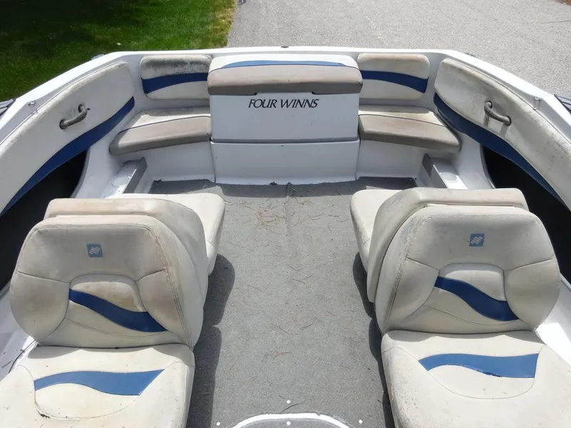 Slide: The Image of 2000 Four Winns 180 Horizon boat interior with seating and carpeted floor. - 17