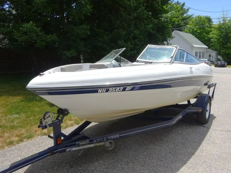 Slide: The Image of 2000 Four Winns 180 Horizon boat on trailer in residential area. - 5