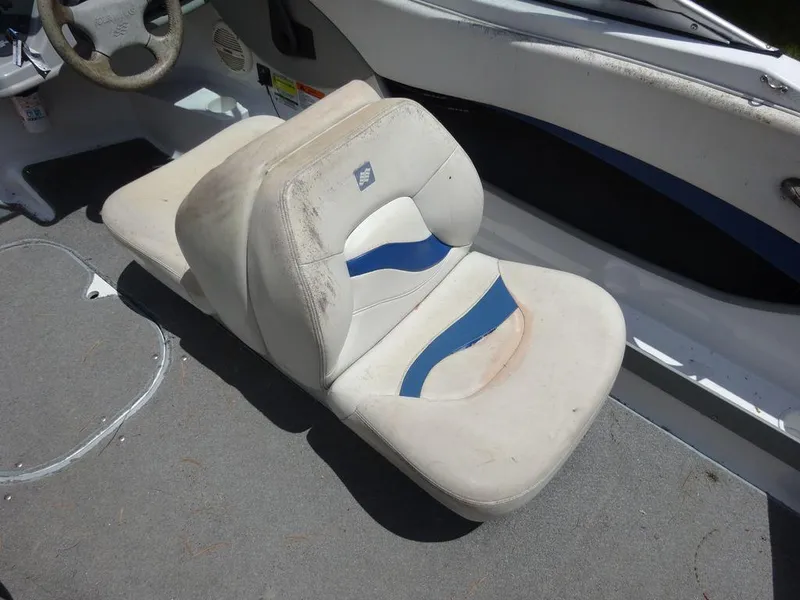 Slide: The Image of 2000 Four Winns 180 Horizon boat interior with worn white and blue seats. - 8