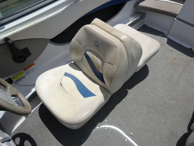 Slide: The Image of 2000 Four Winns 180 Horizon boat interior with worn seats and carpet. - 9