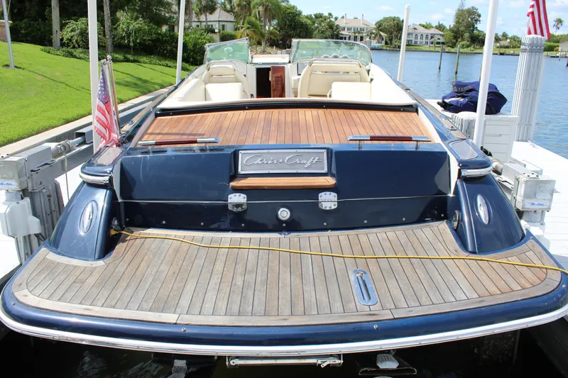 Slide: The Image of 2010 Chris-Craft Corsair 28 boat at dock with wooden deck. - 3