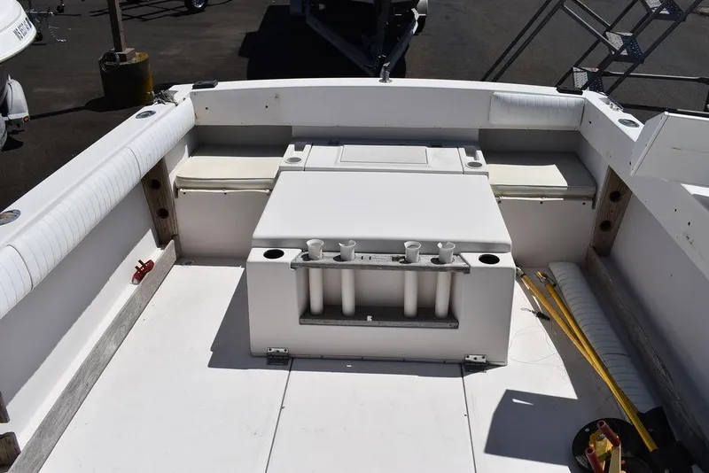 Slide: The Image of 1987 Grady-White Offshore 24 boat deck with storage compartments and rod holders. - 14
