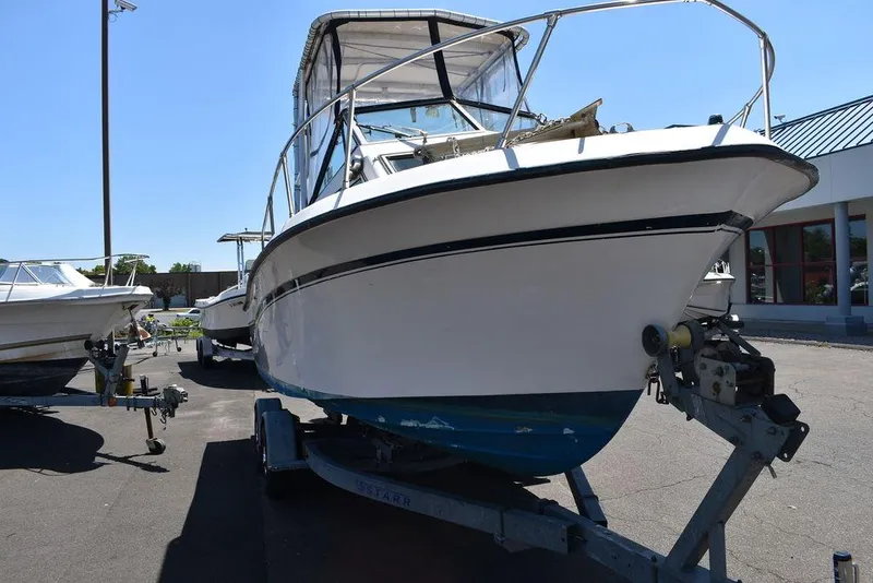 Slide: The Image of 1987 Grady-White Offshore 24 boat on a trailer in a parking lot. - 21