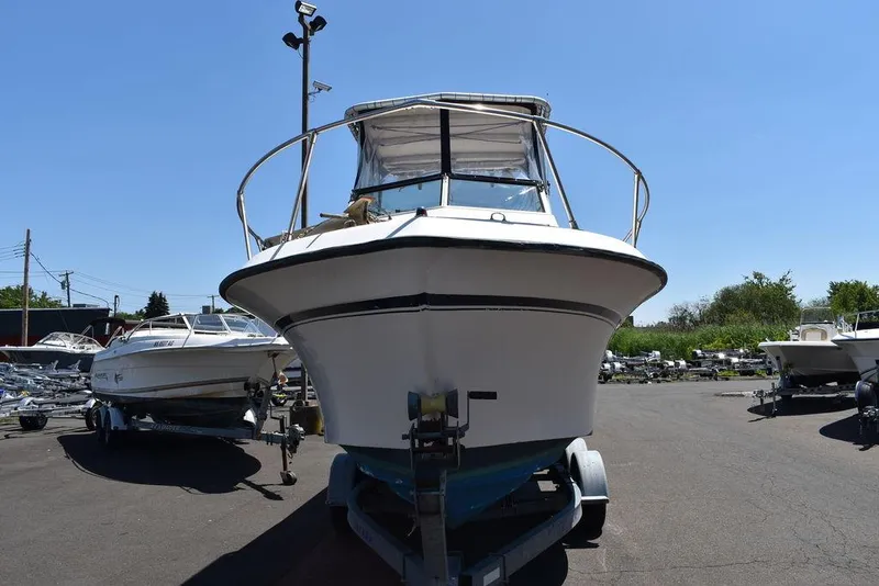 Slide: The Image of 1987 Grady-White Offshore 24 boat on trailer in a marina. - 26