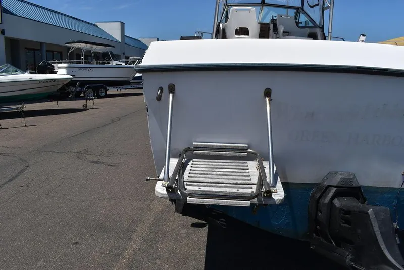 Slide: The Image of 1987 Grady-White Offshore 24 boat stern view with swim platform and ladder. - 28