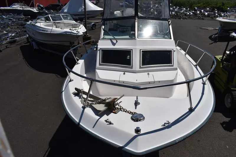 Slide: The Image of 1987 Grady-White Offshore 24 boat, front view, docked in a marina. - 30