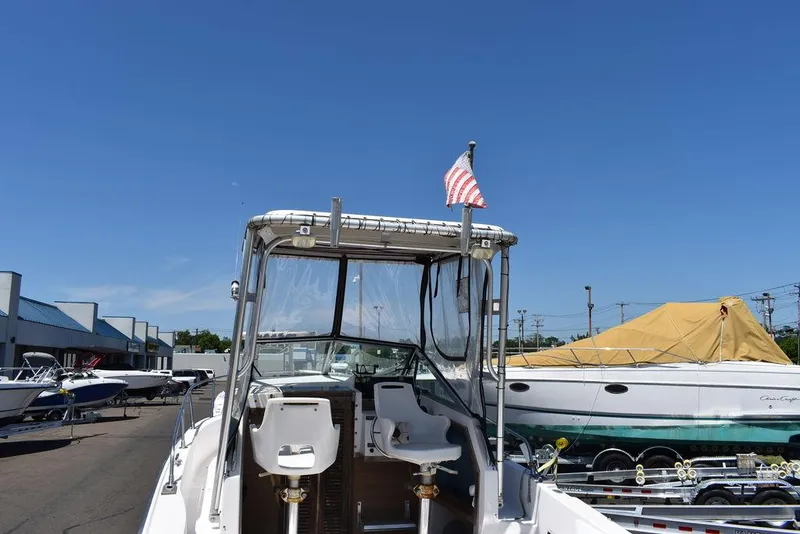 Slide: The Image of 1987 Grady-White Offshore 24 boat with American flag, docked at marina. - 31