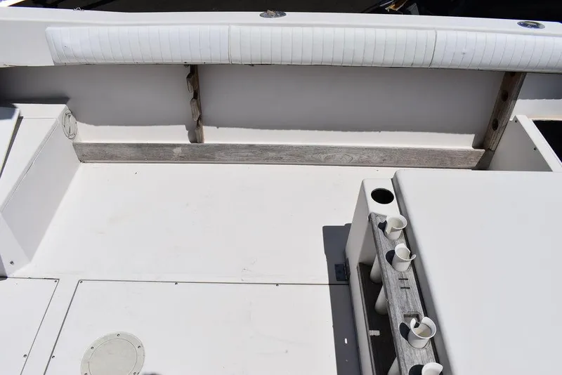Slide: The Image of 1987 Grady-White Offshore 24 boat deck with rod holders and seating. - 32