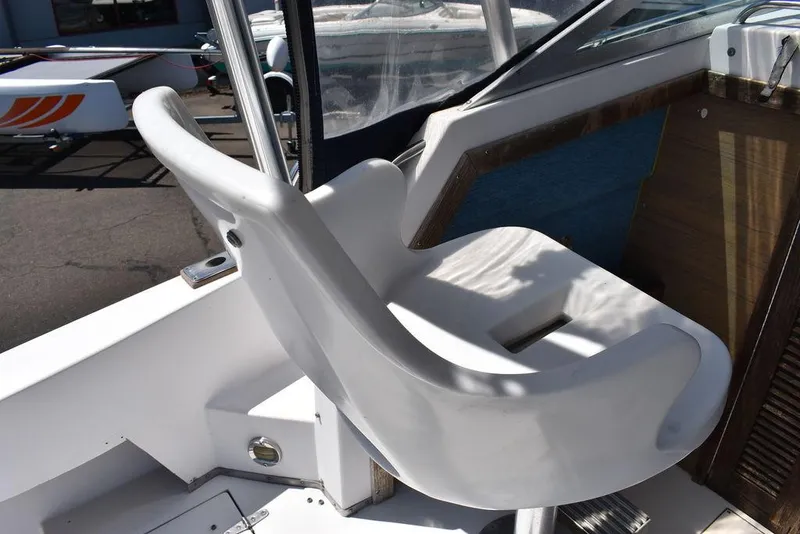 Slide: The Image of 1987 Grady-White Offshore 24 boat captain's chair and cockpit area. - 33