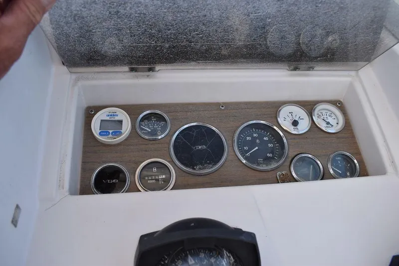 Slide: The Image of 1987 Grady-White Offshore 24 dashboard with various gauges and instruments. - 34
