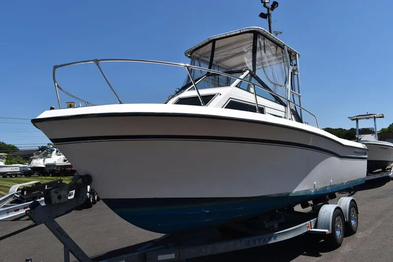 Slide: The Image of 1987 Grady-White Offshore 24 boat on a trailer under clear blue sky. - 4