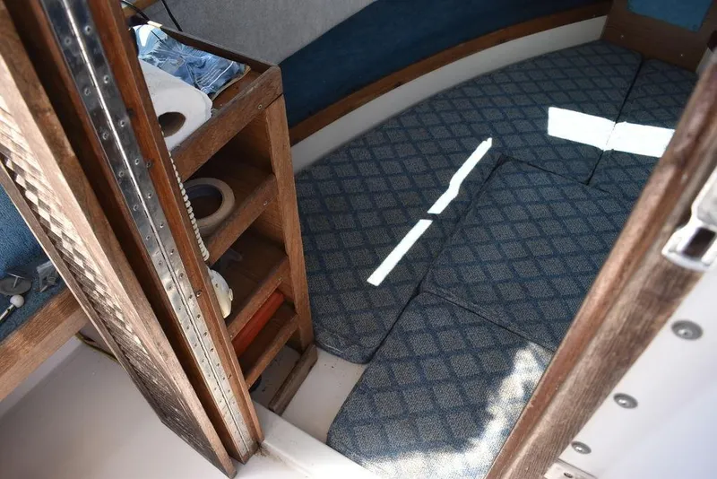 Slide: The Image of Interior cabin of a 1987 Grady-White Offshore 24 boat with blue patterned carpet. - 48