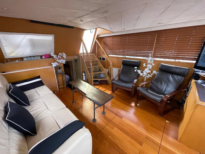 Slide: The Image of 1989 Hi-Star 55 Pilothouse interior with leather seating, wooden flooring, and modern decor. - 10