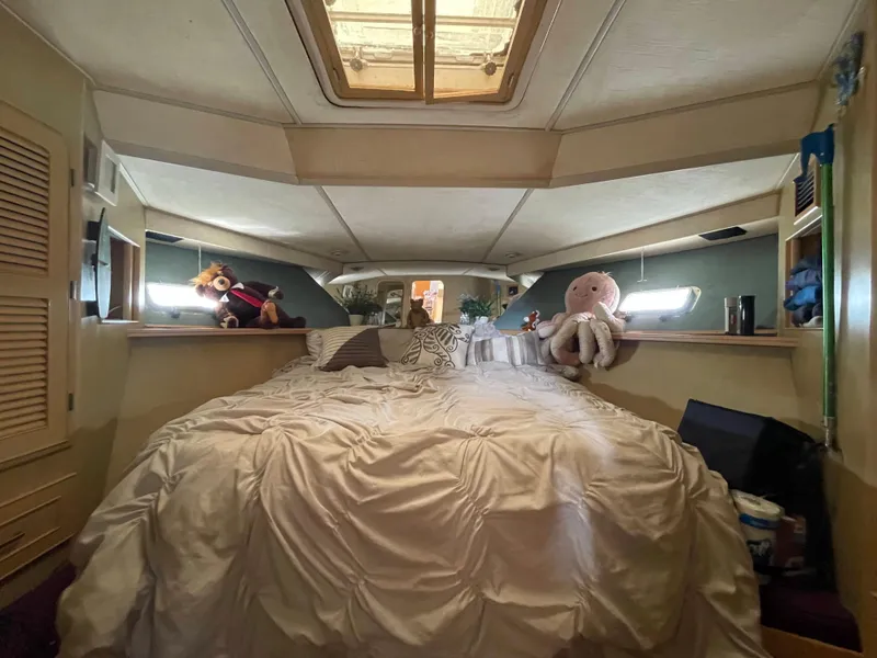 Slide: The Image of 1989 Hi-Star 55 Pilothouse bedroom with plush toys and cozy bedding. - 11