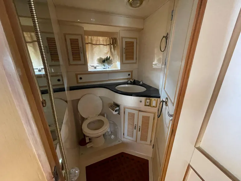 Slide: The Image of 1989 Hi-Star 55 Pilothouse bathroom with sink, toilet, and storage cabinets. - 12