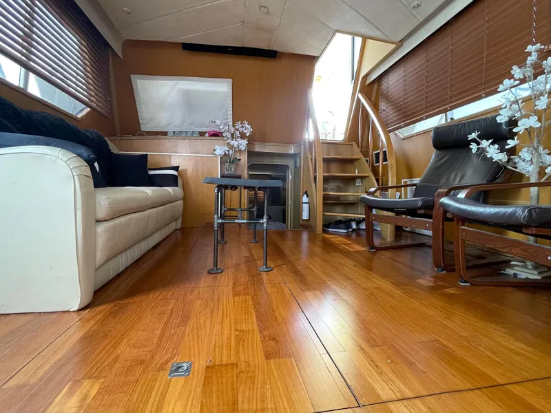 Slide: The Image of Luxurious interior of 1989 Hi-Star 55 Pilothouse with wooden flooring and elegant seating. - 17