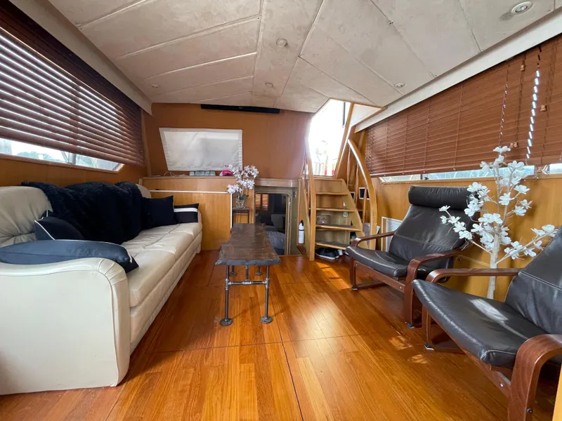 Slide: The Image of Luxurious 1989 Hi-Star 55 Pilothouse interior with wooden flooring and comfortable seating. - 18