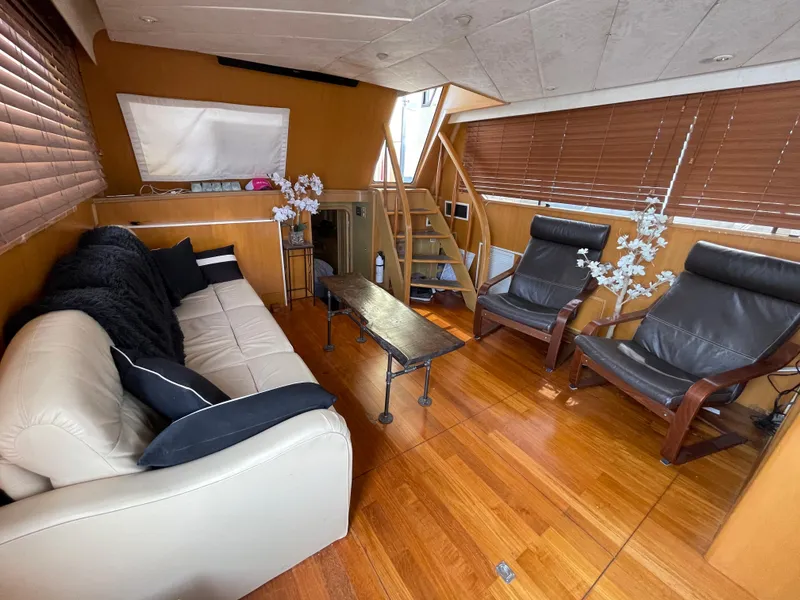 Slide: The Image of 1989 Hi-Star 55 Pilothouse interior with leather sofa, wooden flooring, and modern decor. - 19