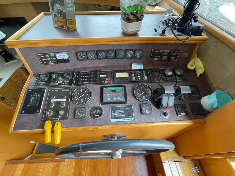 Slide: The Image of 1989 Hi-Star 55 Pilothouse helm with gauges, controls, and steering wheel. - 20