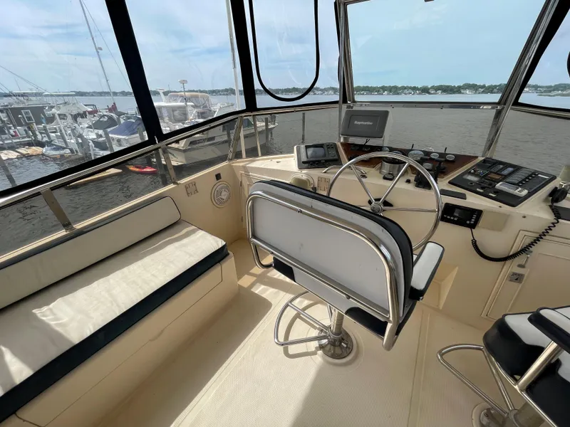 Slide: The Image of 1989 Hi-Star 55 Pilothouse interior with steering wheel, seating, and navigation equipment. - 23