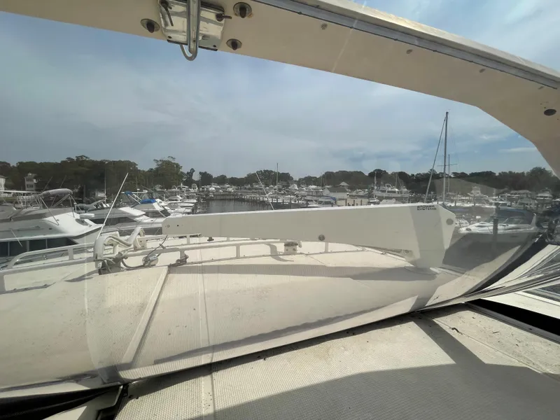 Slide: The Image of 1989 Hi-Star 55 Pilothouse yacht view from deck, overlooking marina with boats. - 24