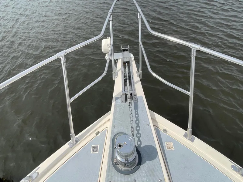 Slide: The Image of Bow view of 1989 Hi-Star 55 Pilothouse yacht with anchor chain and railing. - 27